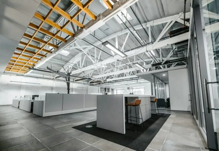 Bespoke mezzanine office installation with glass partitions and LED lighting in warehouse