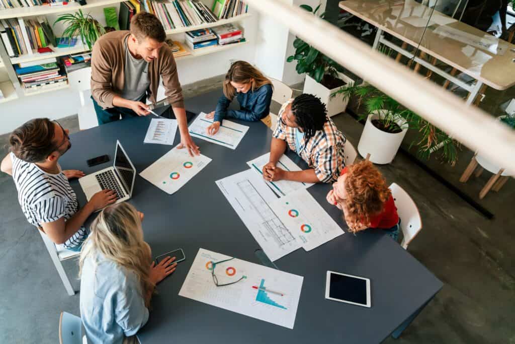 Collaborative office meeting with data charts – example of office design promoting employee engagement and retention