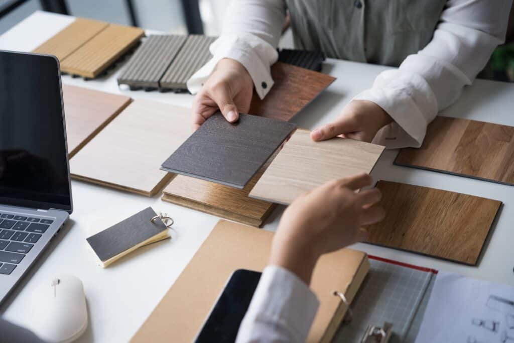 Commercial interior designer selecting sustainable materials and finishes for eco-friendly SME office refurbishment project